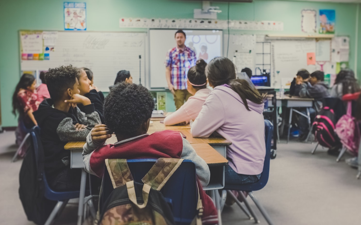 Students exchanging cards in a classroom circle